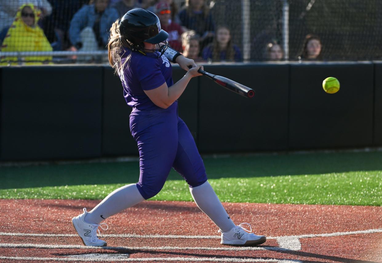 Bloomington South’s Abby Purtlebaugh hits an RBI single to score Carly Reed in the fifth inning during the softball game against North at South on Wednesday, April 24, 2024.