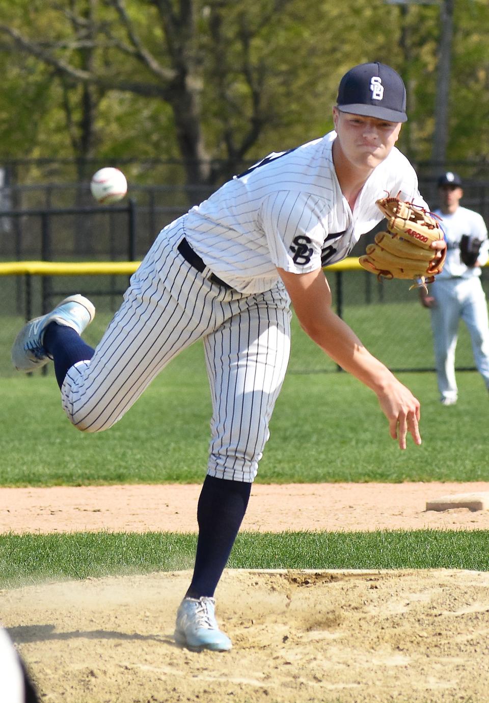 Somerset Berkley's Will Dionne throws a pitch toward the plate.