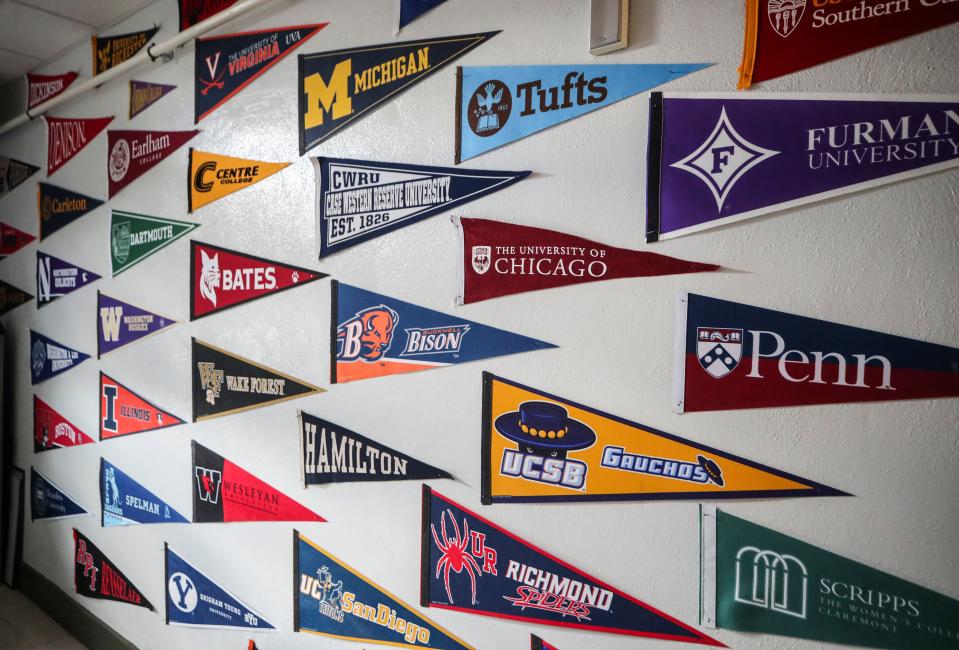 Some of the schools that students of the Ivy+ Academy at Fern Creek High School have matriculated to since graduation on the wall of Beau Baker's office in the school. Aug. 15, 2023