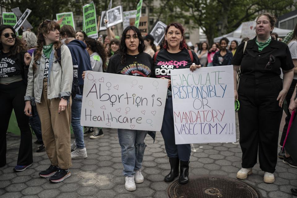 Claudia Orellana, 46, right, and her daughter, Isabella Rosario, 13, stand for a portrait after marching in protest with others from Brooklyn to Manhattan on Saturday, May 14, 2022, in New York. Orellana said she was 12 - younger than her daughter - when she was raped by her uncle. She was five months pregnant when her mother found out and arranged for her to have an abortion. She's 46 now. When she hears abortion opponents propose new laws that lack exceptions, even for rape or incest, and when she looks at her three daughters, she is infuriated. (AP Photo/Wong Maye-E)