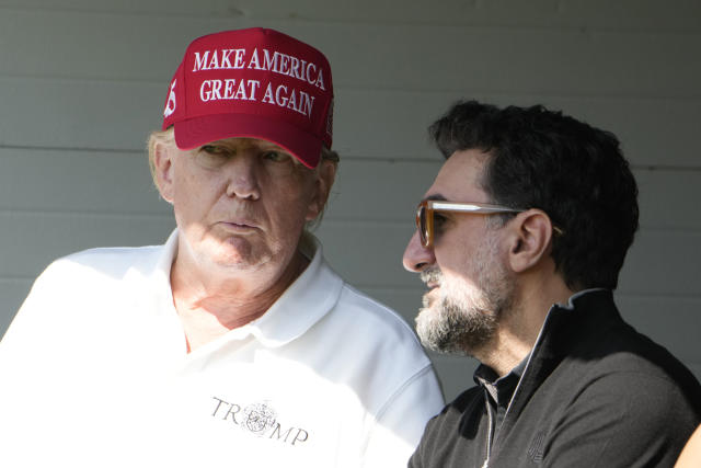 Former President Donald Trump talks with Yasir Al-Rumayyan, during the first round of the LIV Golf Tournament at Trump National Golf Club, Friday, May 26, 2023, in Sterling, Va. (AP Photo/Alex Brandon)