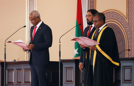 Maldives' President-elect Ibrahim Mohamed Solih (L) takes the oath conducted by Chief Justice Dr Ahmed Abdulla Didi (R) during the swearing-in ceremony in Male, Maldives November 17, 2018. REUTERS/Ashwa Faheem