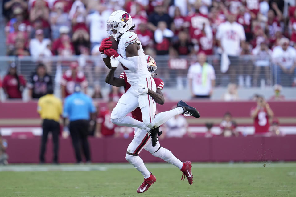 Arizona Cardinals wide receiver Marvin Harrison Jr., top, catches a pass in front of San Francisco 49ers cornerback Isaac Yiadom during the second half of an NFL football game in Santa Clara, Calif., Sunday, Oct. 6, 2024. (AP Photo/Godofredo A. Vásquez)