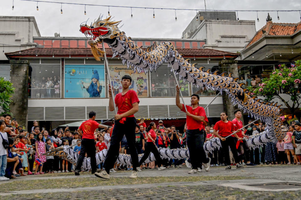 A dragon dance team performs during the first day of the Lunar New Year in Denpasar on the Indonesian resort island of Bali on Feb. 10, 2024. <span class="copyright">Sonny Tumbelaka—Getty Images</span>