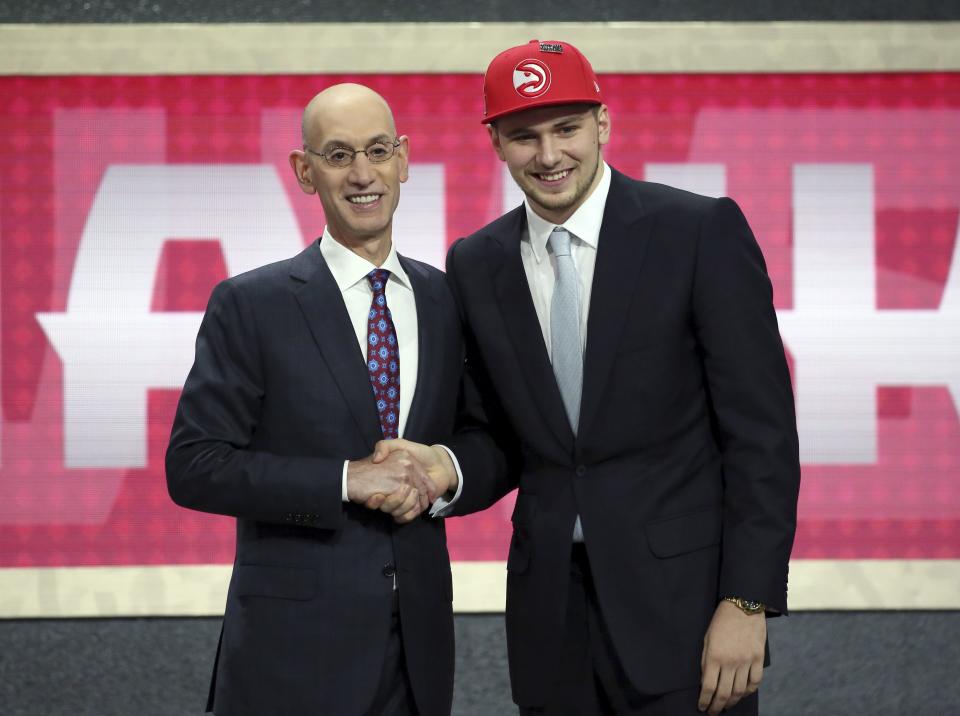 Luka Doncic, who plays for Real Madrid, poses for a picture with NBA Commissioner Adam Silver after Doncic was picked third overall by the Atlanta Hawks during the NBA basketball draft in New York on Thursday, June 21, 2018.