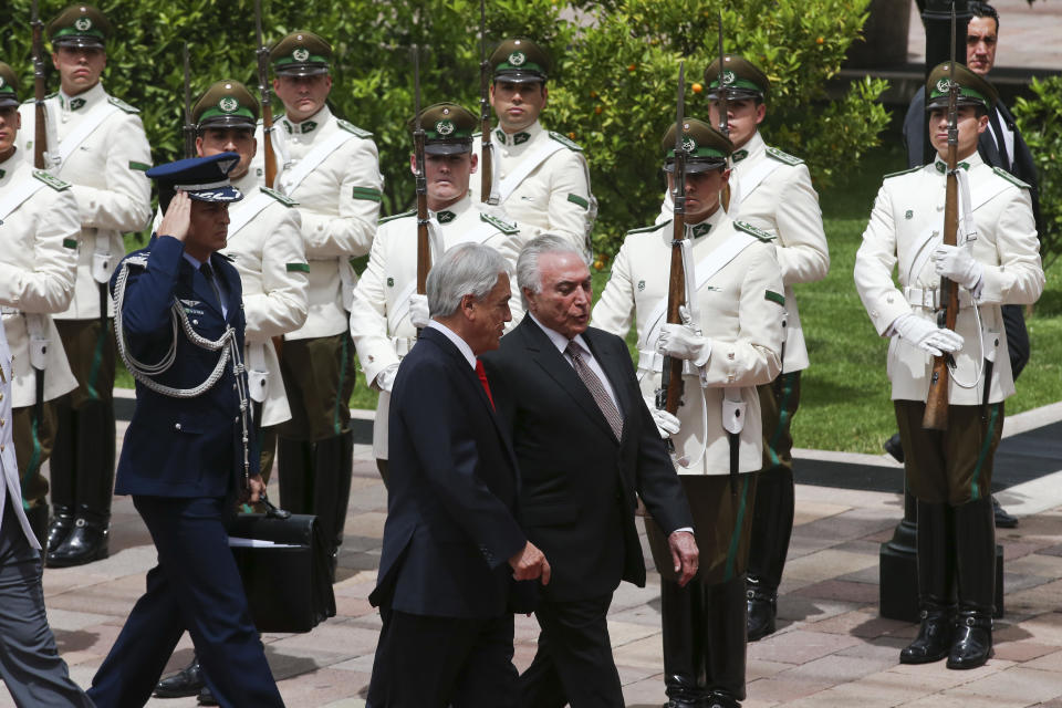 El presidente de Chile, Sebastián Piñera, en la parte central izquierda, camina con el presidente de Brasil, Michel Temer, durante una ceremonia de bienvenida en el Palacio Presidencial La Moneda en Santiago de Chile, el miércoles 21 de noviembre de 2018. (AP Foto / Esteban Félix)