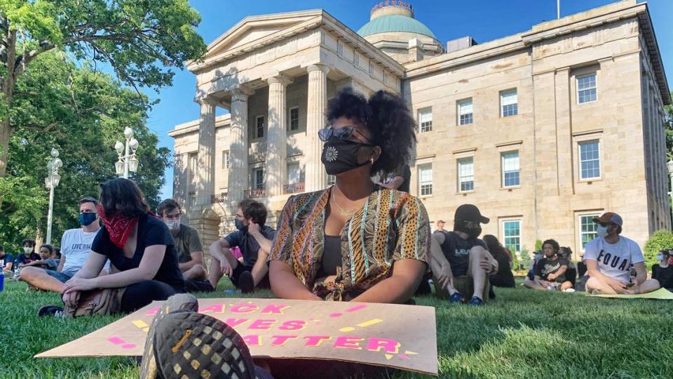 Cynthia Jones of Raleigh sits with other protesters on the grounds of the N.C. State Capitol Sunday afternoon, June 7, 2020.