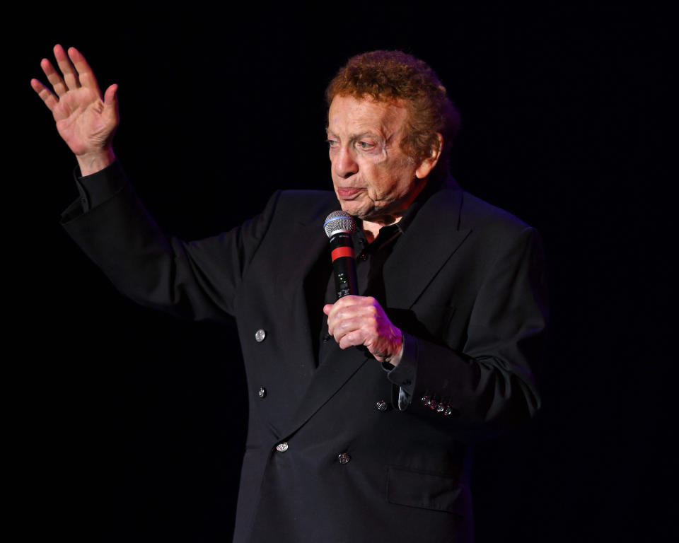 Jackie Mason preforming on stage.