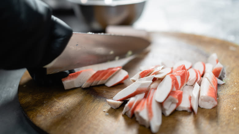 Person cutting imitation crab