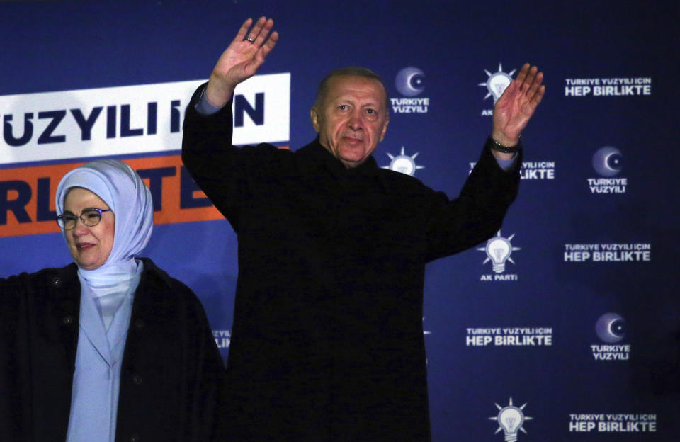 Turkish President Recep Tayyip Erdogan, right, and his wife, Emine, acknowledge supporters at the party headquarters, in Ankara, Turkey, early Monday, May 15, 2023. Erdogan, who has ruled his country with an increasingly firm grip for 20 years, was locked in a tight election race Sunday, with a make-or-break runoff against his chief challenger possible as the final votes were counted. (AP Photo/Ali Unal)