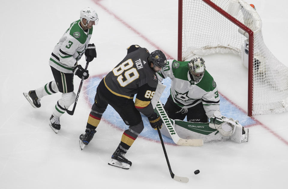 Dallas Stars goalie Ben Bishop (30) makes the save on Vegas Golden Knights' Alex Tuch (89) as Stars' John Klingberg (3) defends during the third period of an NHL hockey playoff game Monday, Aug. 3, 2020, in Edmonton, Alberta. (Jason Franson/The Canadian Press via AP)