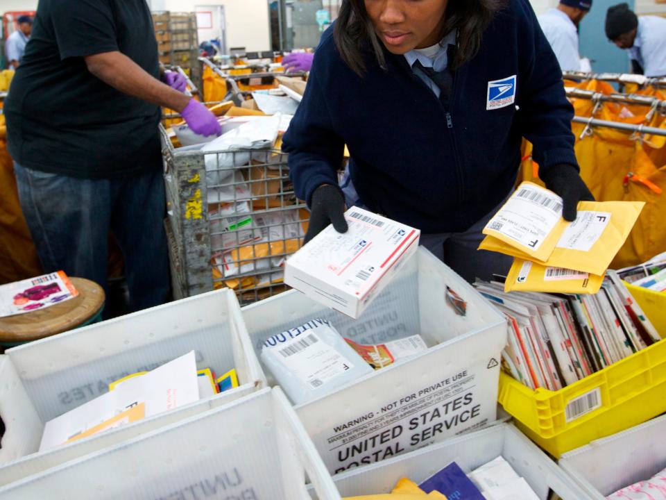 United States Postal Service clerks sort mail at the USPS