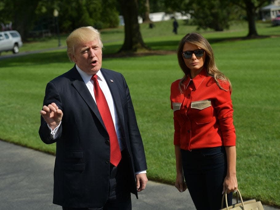 Donald and Melania Trump wearing matching shades of red.