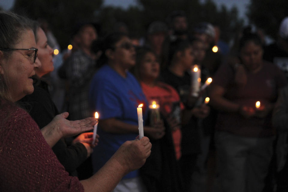 Community members gather for a prayer vigil at Hills Church, Monday, May 15, 2023, in Farmington, N.M. Authorities said an 18-year-old man roamed through the community firing randomly at cars and houses Monday, killing three people and injuring six others including two police officers before he was killed. (AP Photo/Susan Montoya Bryan)