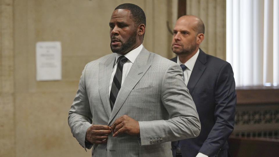 FILE - In this June 6, 2019, file photo, singer R. Kelly pleaded not guilty to 11 additional sex-related felonies during a court hearing before Judge Lawrence Flood at Leighton Criminal Court Building in Chicago. R. Kelly, already facing sexual abuse charges brought by Illinois prosecutors, was arrested in Chicago Thursday, July 11, 2019 on a federal grand jury indictment listing 13 counts including sex crimes and obstruction of justice. (E. Jason Wambsgans/Chicago Tribune via AP, Pool)