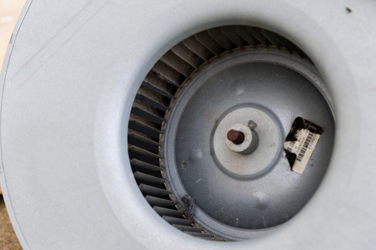 Biological growth is visible on a barcode sticker on the blower housing before cleaning.