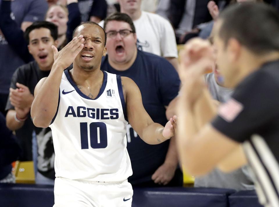 Utah State guard Darius Brown II pleads with an official to get a foul call during the Aggies’ win over East Tennessee State Dec. 23 at the Spectrum in Logan. | Jeff Hunter