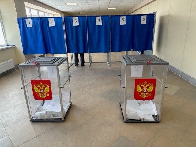 Ballot boxes marked with the coat of arms of the Russian Federation are seen at a polling place in Russian-occupied Ukraine during elections in September 2023.