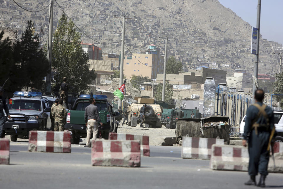 Afghan security personnel man near a house where attackers are hiding, in Kabul, Afghanistan, Tuesday, Aug. 21, 2018. Afghan police say the Taliban fired rockets toward the presidential palace in Kabul as President Ashraf Ghani was giving his holiday message for the Muslim celebrations of Eid al-Adha. (AP Photo/Rahmat Gul)