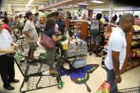 People stand in line for last minute shopping pending the arrival of Hurricane Matthew in Kingston, Jamaica, October 1, 2016. REUTERS/Gilbert Bellamy