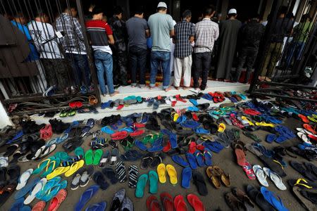 Muslims perform Eid al-Fitr prayers at a mosque inside city hall compound as government forces continue their assault against insurgents from the Maute group, who have taken over large parts of Marawi City, Philippines June 25, 2017. REUTERS/Jorge Silva