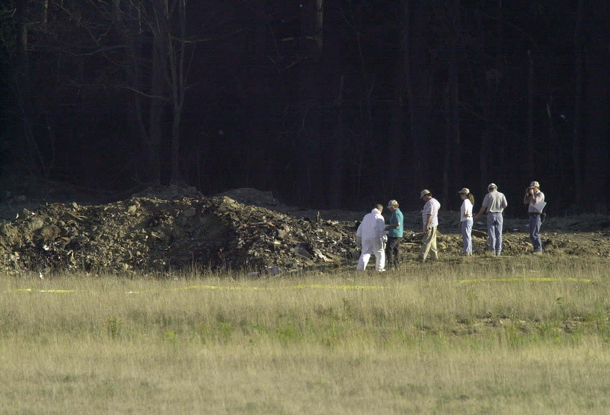 Officials examine the wreckage of United Airlines Flight 93 in Shanksville, Pennsylvania (AFP via Getty Images)