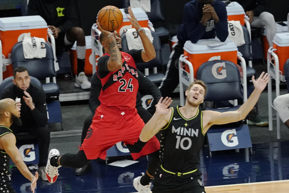 Toronto Raptors' Norman Powell (24) shoots as he is fouled by Minnesota Timberwolves' Jake Layman (10) during the second half of an NBA basketball game Friday, Feb. 19, 2021, in Minneapolis. (AP Photo/Jim Mone)