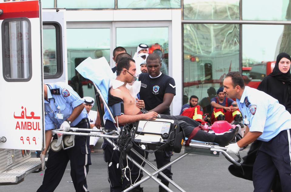 A survivor of a fire receives medical attention after a fire took hold of the Villaggio Mall, in Doha's west end, in the Qatari capital of Doha Monday May 28, 2012. Qatar's Interior Ministry said 13 children were among 19 people killed in a fire that broke out at one of the Gulf state's fanciest shopping mall on Monday. The Villaggio opened in 2006 and is one of Qatar's most popular shopping and amusement destinations. It includes an ice skating rink and indoor Venice-style gondola rides. (AP Photo/Osama Faisal)