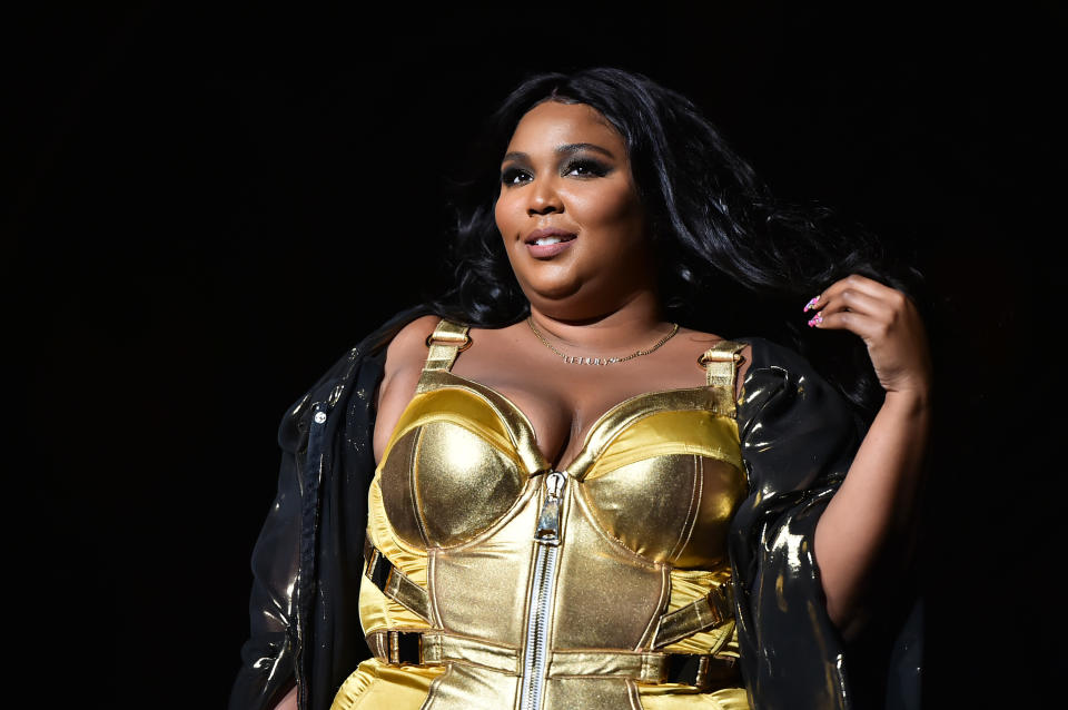 Lizzo Wearing Black Jacket And Gold Outfit