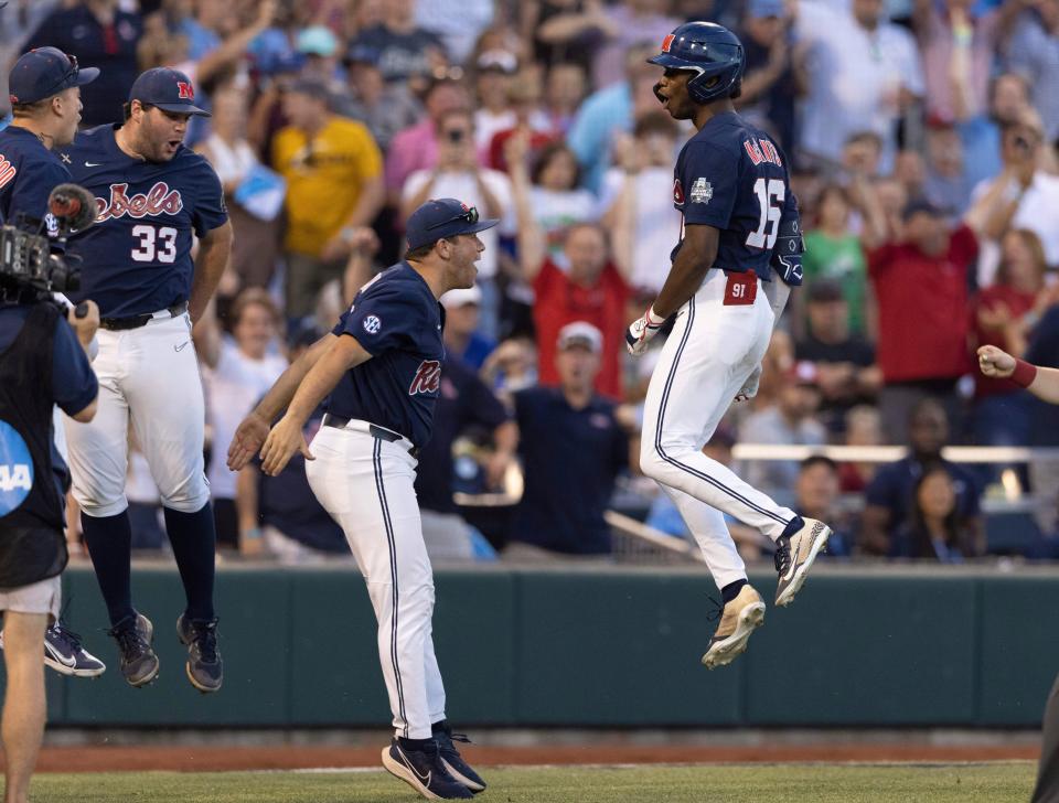 From left, Mississippi's Ben Van Cleve (33) and Dylan DeLucia, center celebrate with TJ McCants (16) after McCants hit a two-run home run against Oklahoma in the eighth inning during the first championship baseball game of the NCAA College World Series, Saturday, June 25, 2022, in Omaha, Neb. (AP Photo/Rebecca S. Gratz)