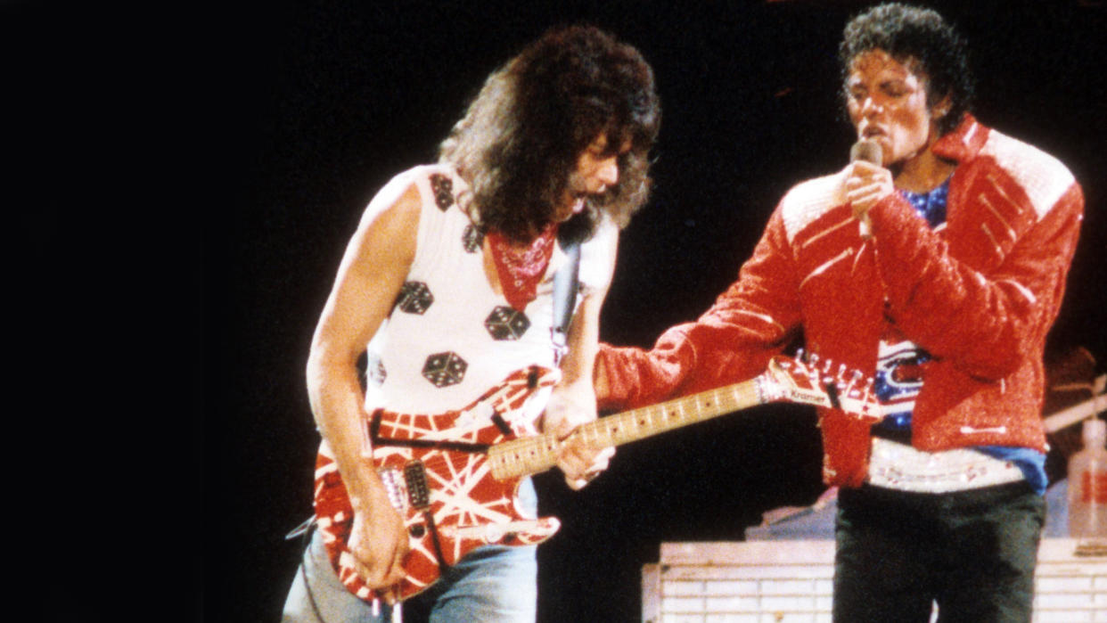  Eddie Van Halen plays guitar on stage with Randy Jackson, Michael Jackson and Jermaine Jackson during the Victory Tour 