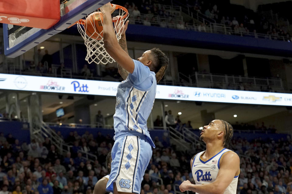 North Carolina guard Armando Bacot (5), left, dunks over Pittsburgh guard Ishmael Leggett (5), right, during the first half of an NCAA college basketball game Tuesday, Jan. 2, 2024, in Pittsburgh. (AP Photo/Matt Freed)