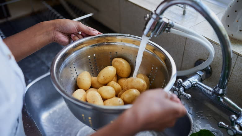 Rinsing potatoes in colander
