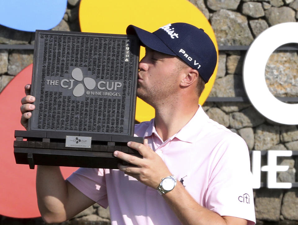 Justin Thomas of the United States kisses his trophy after winning the CJ Cup PGA golf tournament at Nine Bridges on Jeju Island, South Korea, Sunday, Oct. 20, 2019. (Chun Jin-hwan/Newsis via AP)