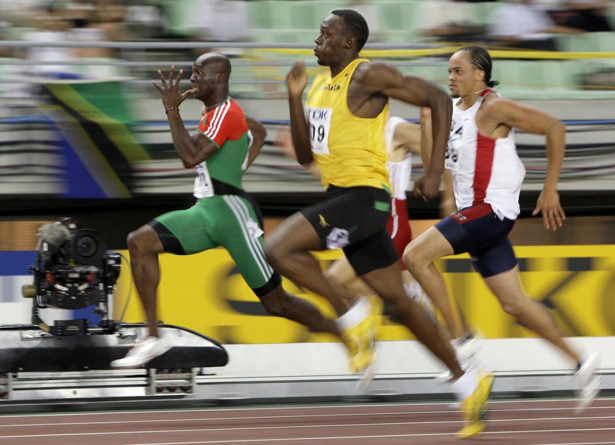 Jamaican sprinter Usain Bolt, in yellow, holds the world's speed record for humans. <a href="https://newsroom.ap.org/detail/WorldTFChampionships-Mens400m/16bacfc487364561a1ff3207cb72bb8b/photo" rel="nofollow noopener" target="_blank" data-ylk="slk:AP Photo/David J. Phillip;elm:context_link;itc:0;sec:content-canvas" class="link ">AP Photo/David J. Phillip</a>