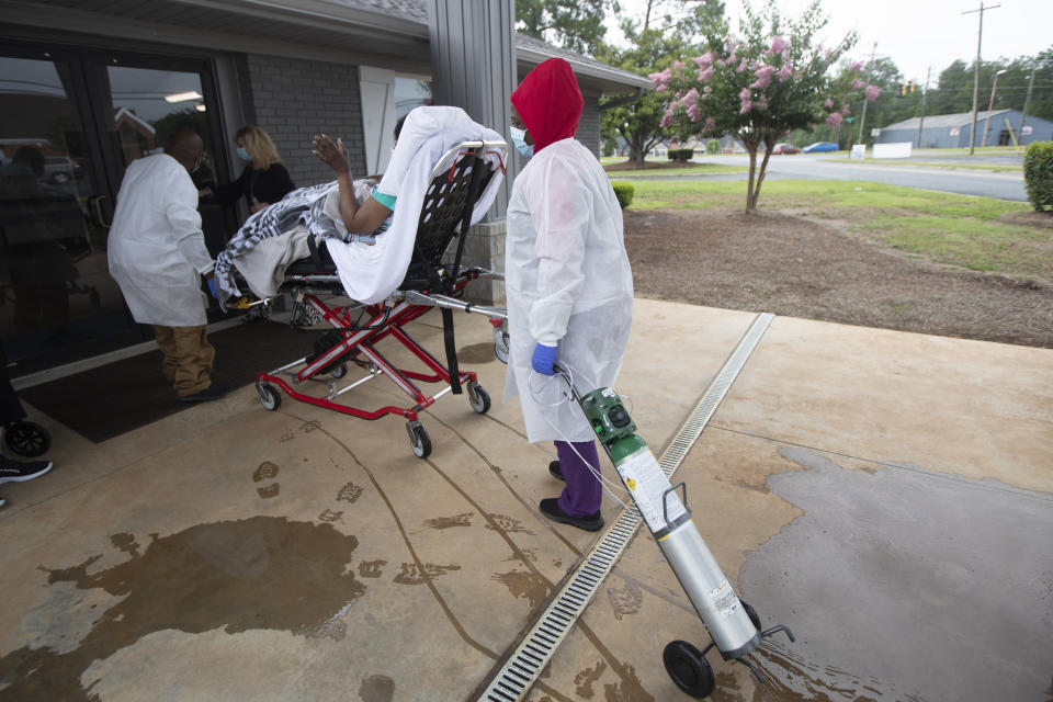 A resident on a stretcher is brought back to Southern Pines in Warner Robins, Ga., on Thursday, June 25, 2020. With a coronavirus lockdown in place, the only tickets out may be a trip to dialysis or an ambulance ride to the hospital — or something worse. (AP Photo/John Bazemore)