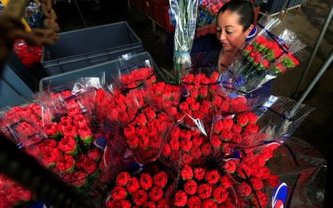 Red roses bouquets for Valentine's Day - Credit: Jaime Saldarriaga/Reuters