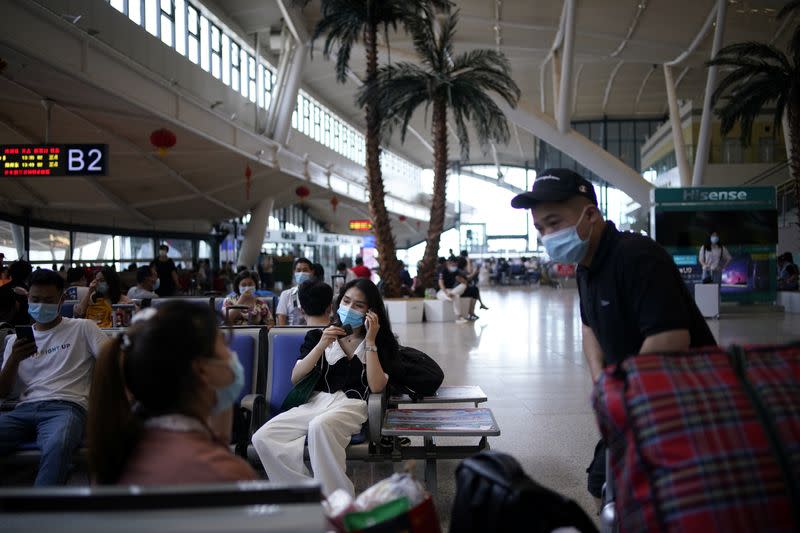 People wearing face masks are seen at Wuhan Railway Station, in Wuhan