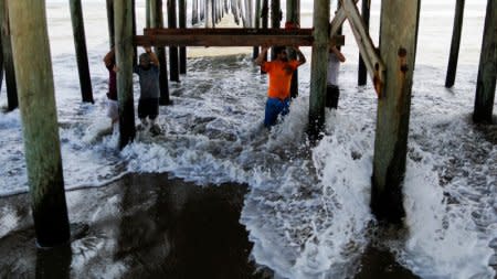 People work in the reconstruction of Rodanthe pier after being partially damaged after the pass of Hurricane Florence, now downgraded to a tropical depression in Rodanthe, North Carolina, U.S., September 18, 2018. REUTERS/Eduardo Munoz