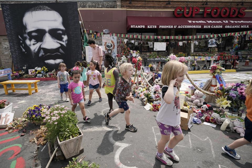 FILE - Preschool children visit the site where George Floyd was murdered by then Minneapolis Police officer Derek Chauvin, as the kids took a field trip to the memorial, June 24, 2021, in Minneapolis. The third anniversary of Floyd’s murder is Thursday, May 25, 2023. (AP Photo/Julio Cortez, File)