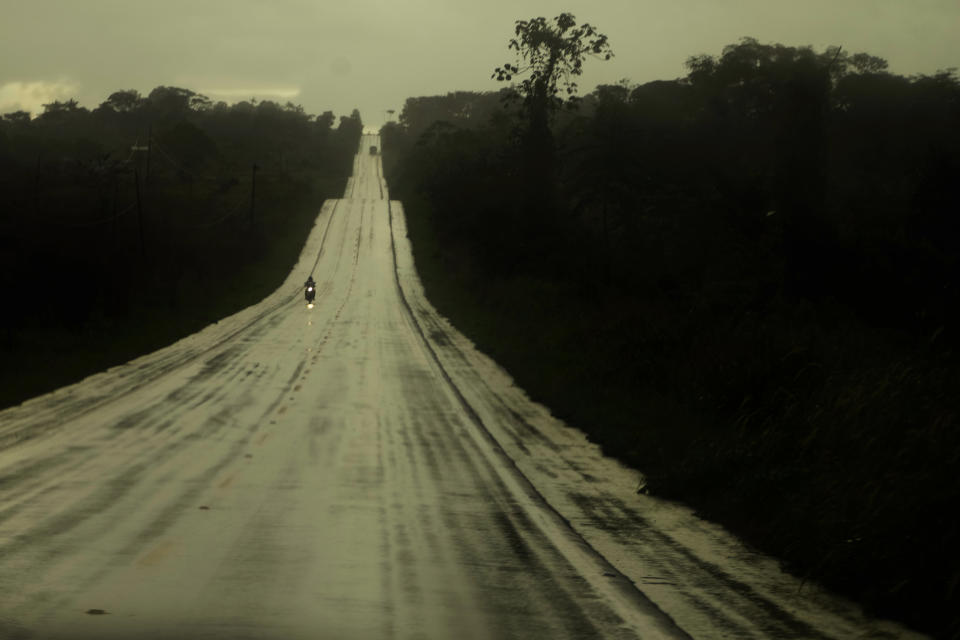 Drivers travel along a road to access farms and transport agricultural products in the rural area of the Rio Branco, Acre state, Brazil, Thursday, May 25, 2023. (AP Photo/Eraldo Peres)