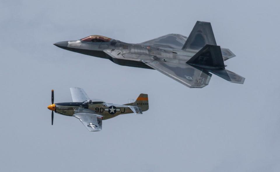The F-22 Raptor cruises alongside a World War II-era P-51 Mustang during the Heritage Flight at the Friday afternoon airshow at Sun 'n Fun in Lakeland on April 16, 2021.