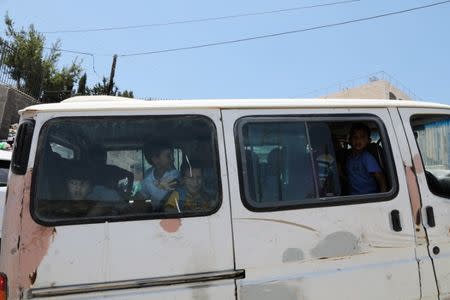 Palestinian school children ride a van in the East Jerusalem neighbourhood of Jabel Mukhaber June 12, 2017. REUTERS/Ammar Awad