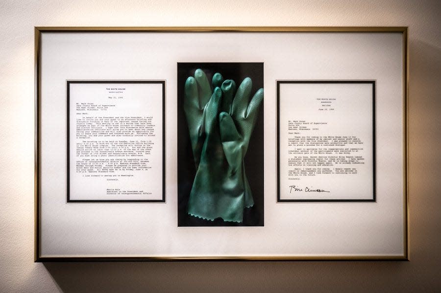 A pair of blue rubber gloves, flanked by two White House letters hang in U.S. Rep. Mark Pocan's office in D.C., in remembrance of a visit to the White House in 1995 where he and others were shamed for their sexuality by security.