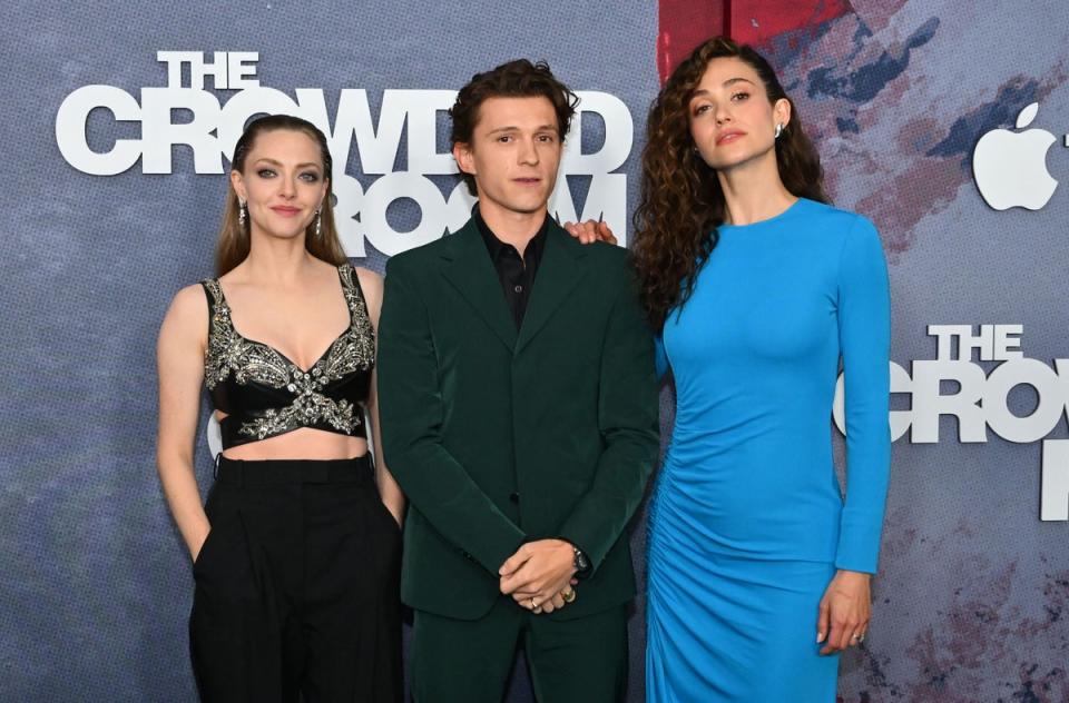 Actors Amanda Seyfried (L), Tom Holland (C) and Emmy Rossum (R) (AFP via Getty Images)