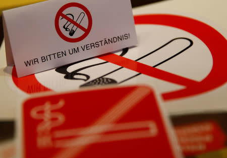 No smoking signs are seen on a table in a sign shop in Vienna, Austria March 8, 2018. REUTERS/Leonhard Foeger