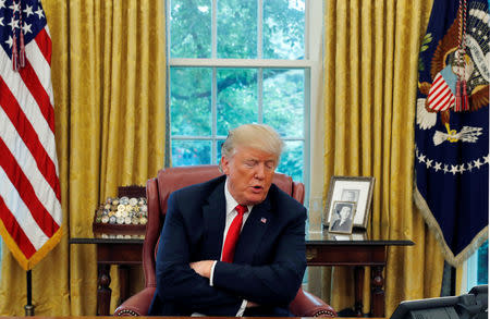 U.S. President Donald Trump answers a question during an interview with Reuters in the Oval Office of the White House in Washington, U.S. August 20, 2018. REUTERS/Leah Millis