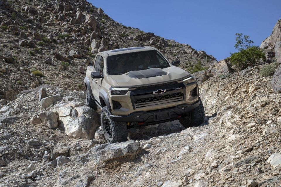 The 2024 Colorado ZR2 Bison rock crawling on an off-road trail.