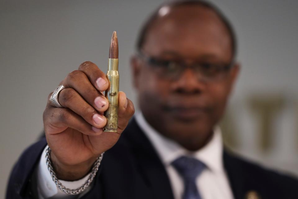 A police recruit in Texas is now in prison after admitting he spent a year as a straw purchaser for buyers in Mexico seeking a bevy of .50-caliber bullets similar to this one held by veteran lawman Jonathan T. McPherson, head of the ATF's Seattle Field Division.