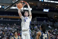 Creighton's Ryan Kalkbrenner (11) dunks over Akron's Nate Johnson (34) during the second half of a first-round college basketball game in the NCAA Tournament, Thursday, March 21, 2024, in Pittsburgh. (AP Photo/Matt Freed)
